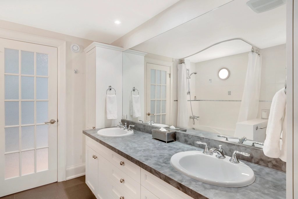 Vanity light and faucet fixtures installed in a bathroom