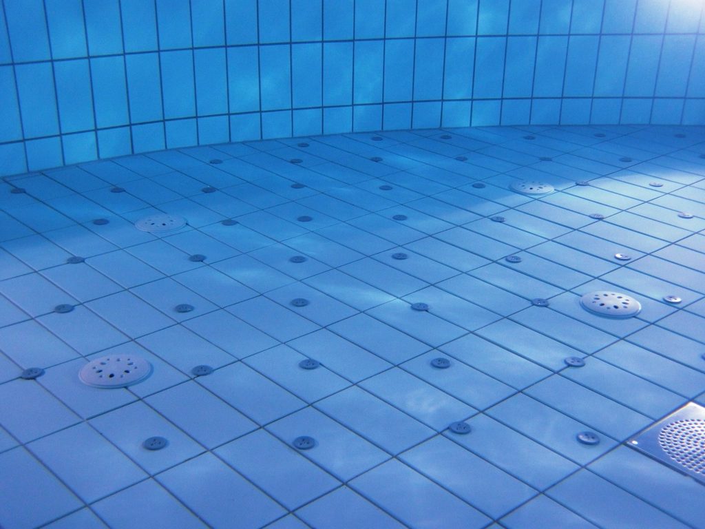 Pool waterline tile cleaned and reset