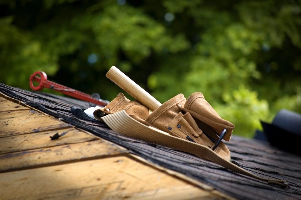 Roofing tools and materials staged for gutter work